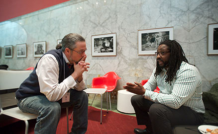 Two men sitting and talking during the family engagement celebration at the Children's Museum of Pittsburgh.