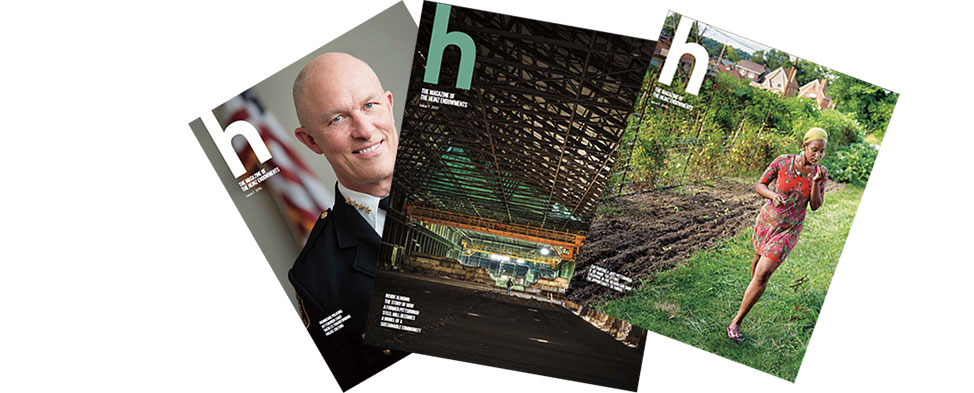 Covers of three issues of h magazine, fanned-out.