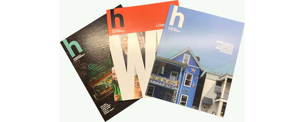 Covers of three issues of h magazine, fanned-out.