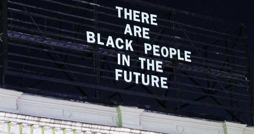 Billboard sign at the top of a building that read, "There are black people in the future."