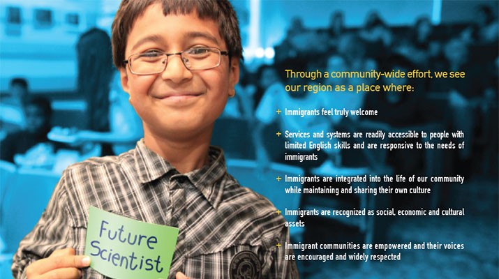 Photo of a young immigrant boy holding up a small sign that says, "Future Scientist."
