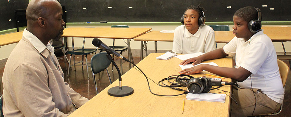 Two young men conducting an interview for Crossing Fences.