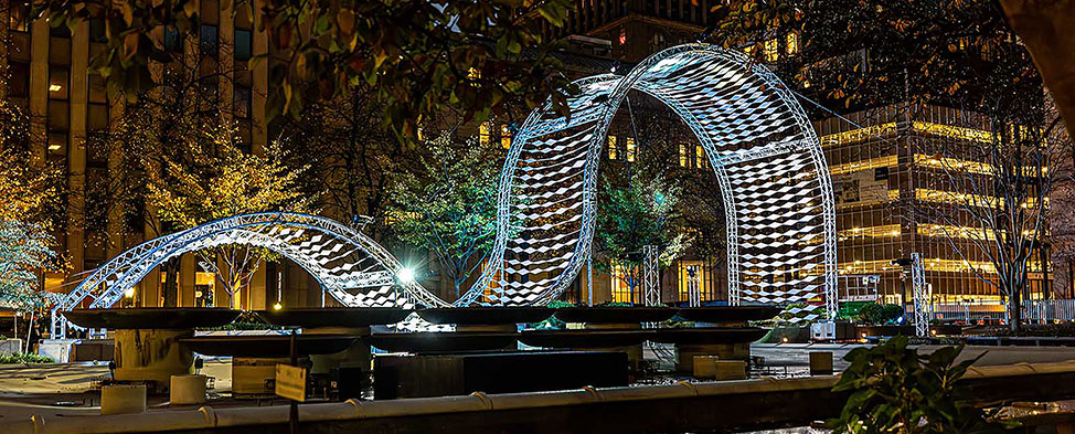 Light installation by Joshua Challen Ice,  Aurora, 2024, illuminates Mellon Square. Photo by John Altdorfer courtesy Pittsburgh Parks Conservancy/Shiftworks Community & Public Arts.