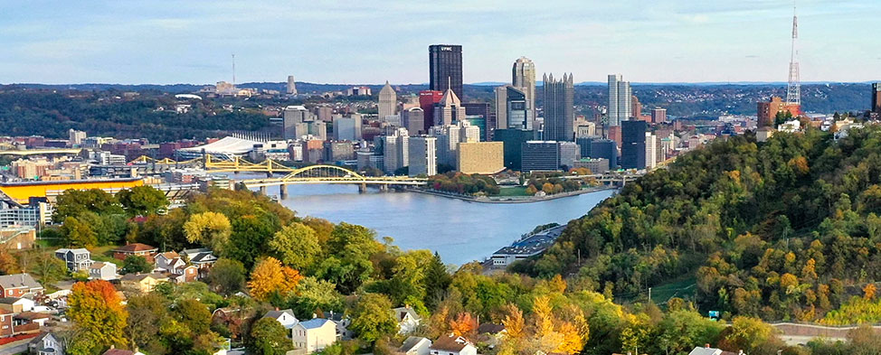Pittsburgh skyline with neighborhood in the foreground.