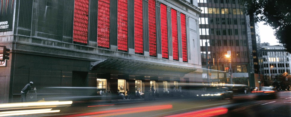 Wood Street Station with red lights and blurred passing cars.