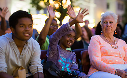 Audience members participate by raising their hands at the Three Rivers Arts Festival.