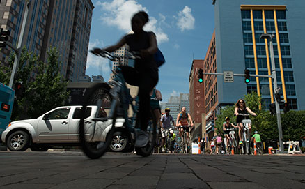 People riding bikes through Downtown Pittsburgh during 2016 OpenStreetsPGH when certain streets were closed to automobiles.
