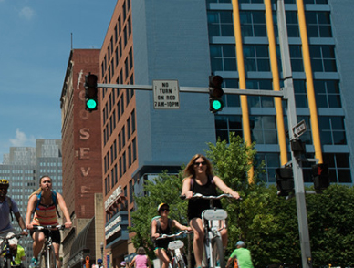 People riding bikes through Downtown Pittsburgh during 2016 OpenStreetsPGH when certain streets were closed to automobiles.