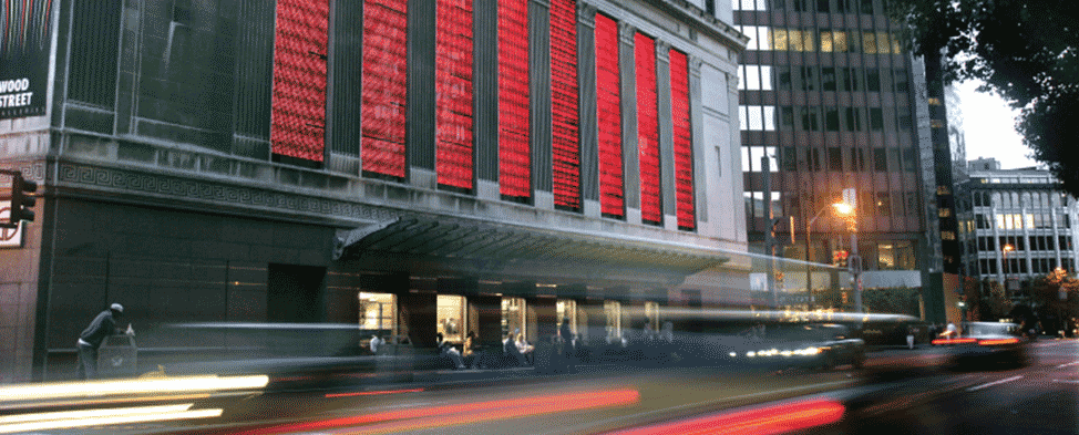 Street view of the Wood Street Galleries with cars going by at the corner of Wood Street and Sixth Avenue in Downtown Pittsburgh.