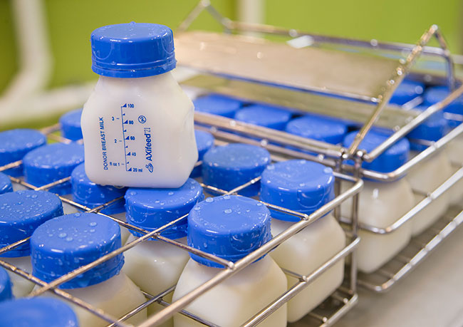 Four ounce bottles with blue caps of donated breast milk, packaged and ready to go from the Three Rivers Mothers' Milk Bank.
